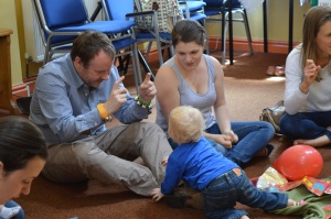 Mum, dad and toddler enjoying music and signing